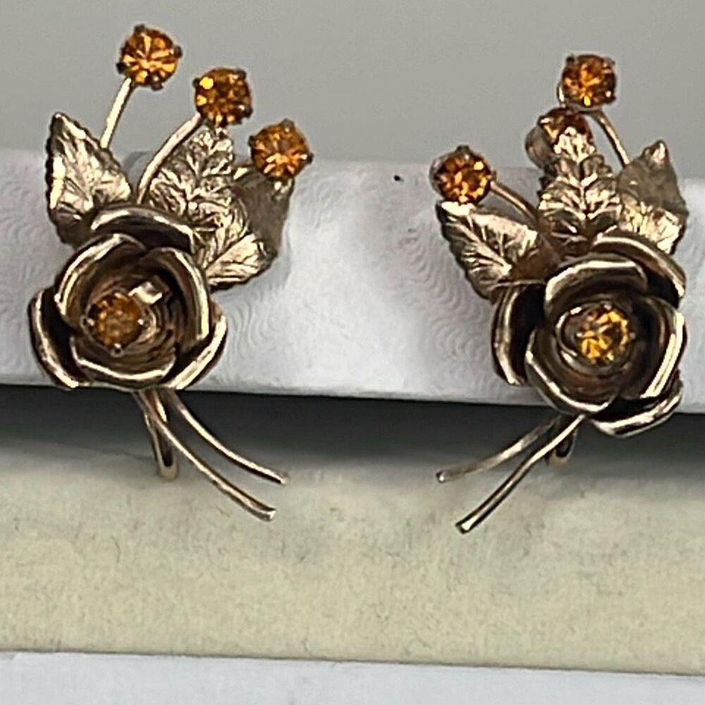 Vintage flower sprays climber earrings. Gold plated amber glass.